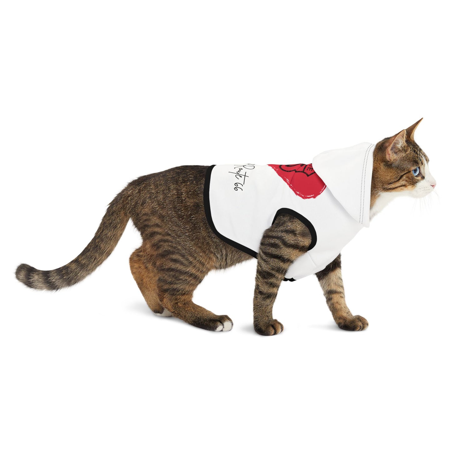 Brown tabby cat walking in a white Route 66 pet hoodie with black ribbed trim and a large red heart design, with a Route 66 shield inside the heart and text that reads "The Heart of Route 66."
