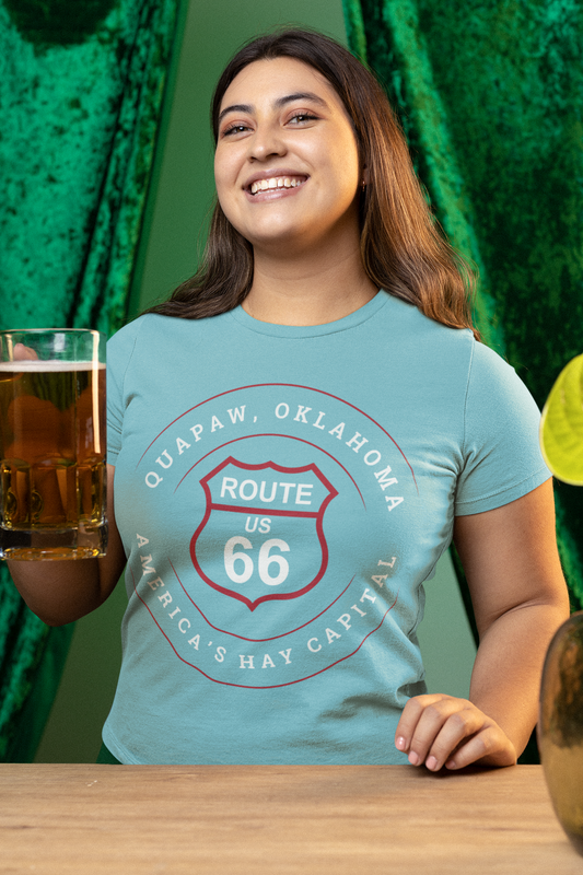 Female model wearing turquoise retro Route 66 unisex jersey tee with Quapaw, OK "America's Hay Capital"  design