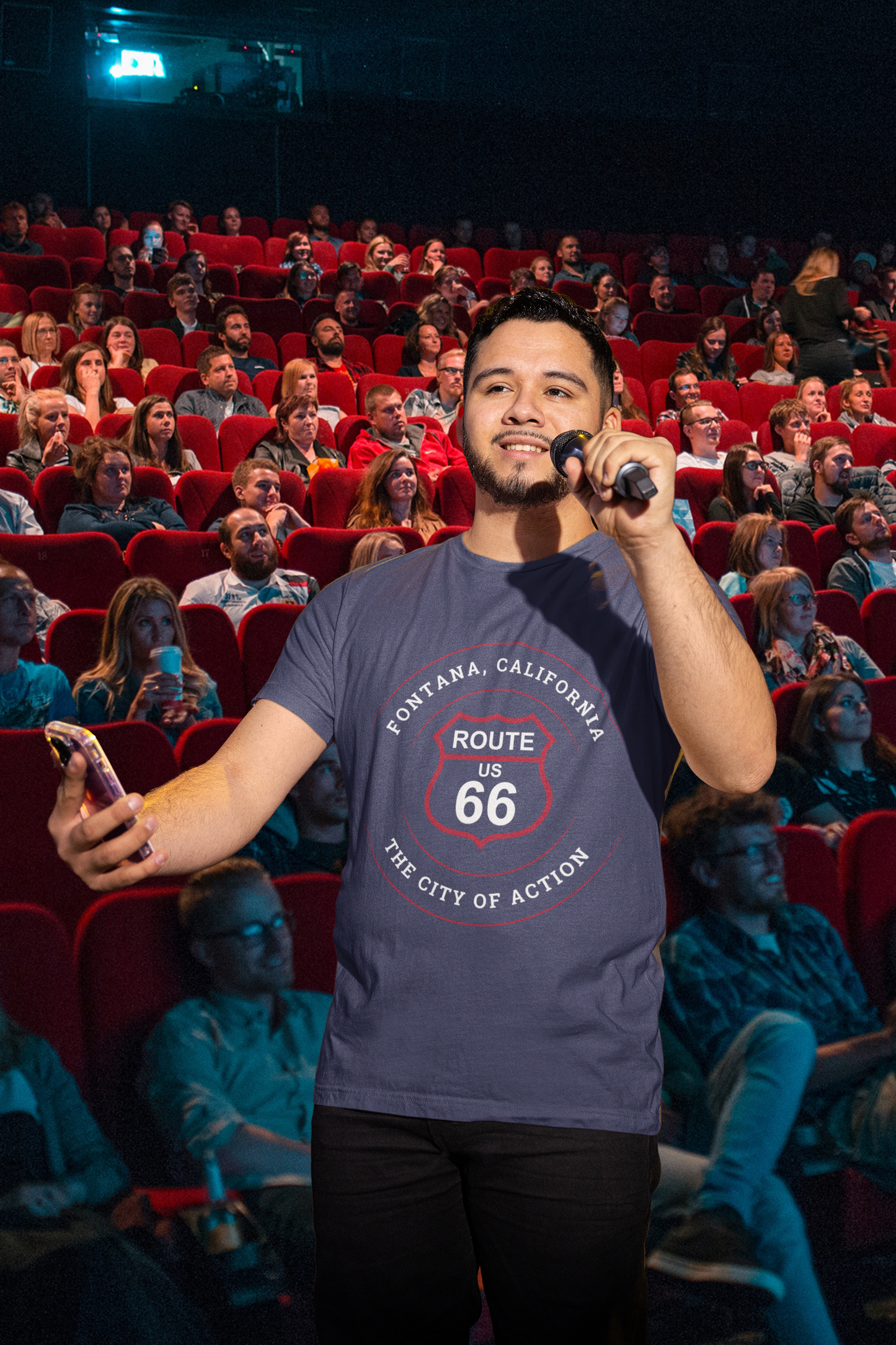Male inspirational speaker talking to audience and wearing a heather navy retro Route 66 unisex jersey tee with Fontana, CA: "The City of Action" design