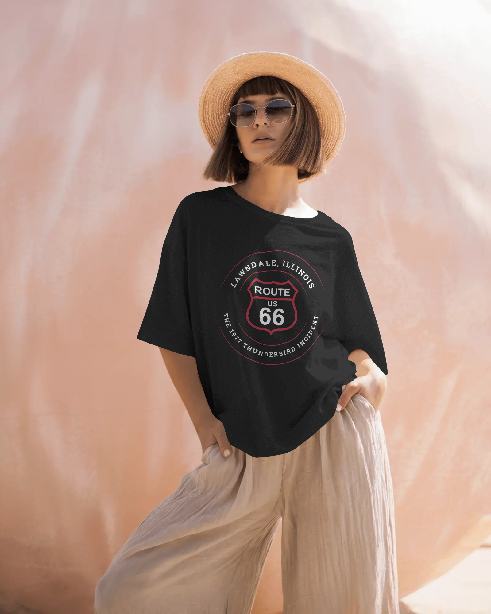 Woman wearing a straw hat and a Route 66 retro unisex jersey tee Lawndale, IL "The 1977 Thunderbird Incident" design.