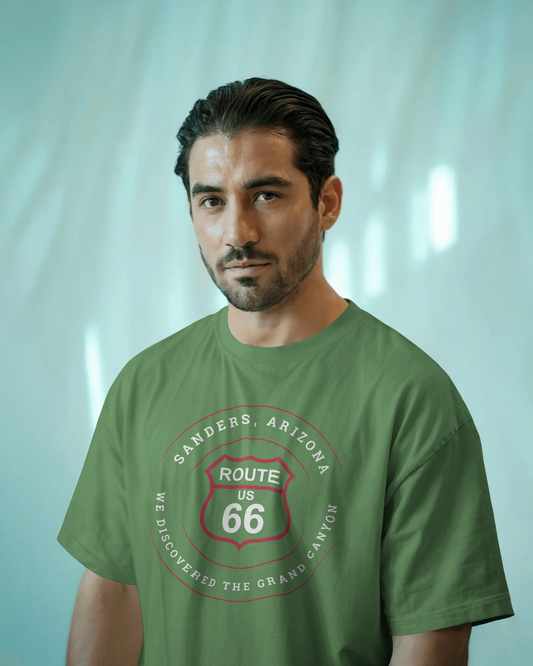 Male model wearing leaf retro Route 66 unisex jersey tee with Sanders, AZ: "We Discovered the Grand Canyon" design