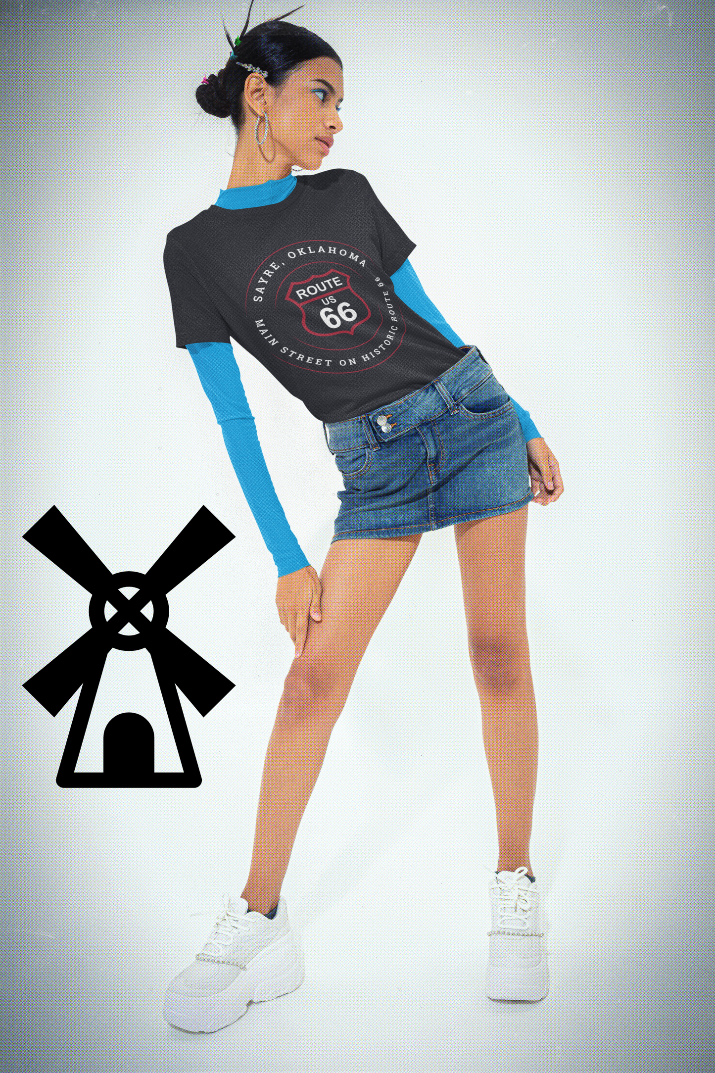 Female model wearing vintage black retro Route 66 unisex jersey tee with Sayre, OK "Main Street on Historic Route 66" design and an aqua colored long-sleeved shirt underneath