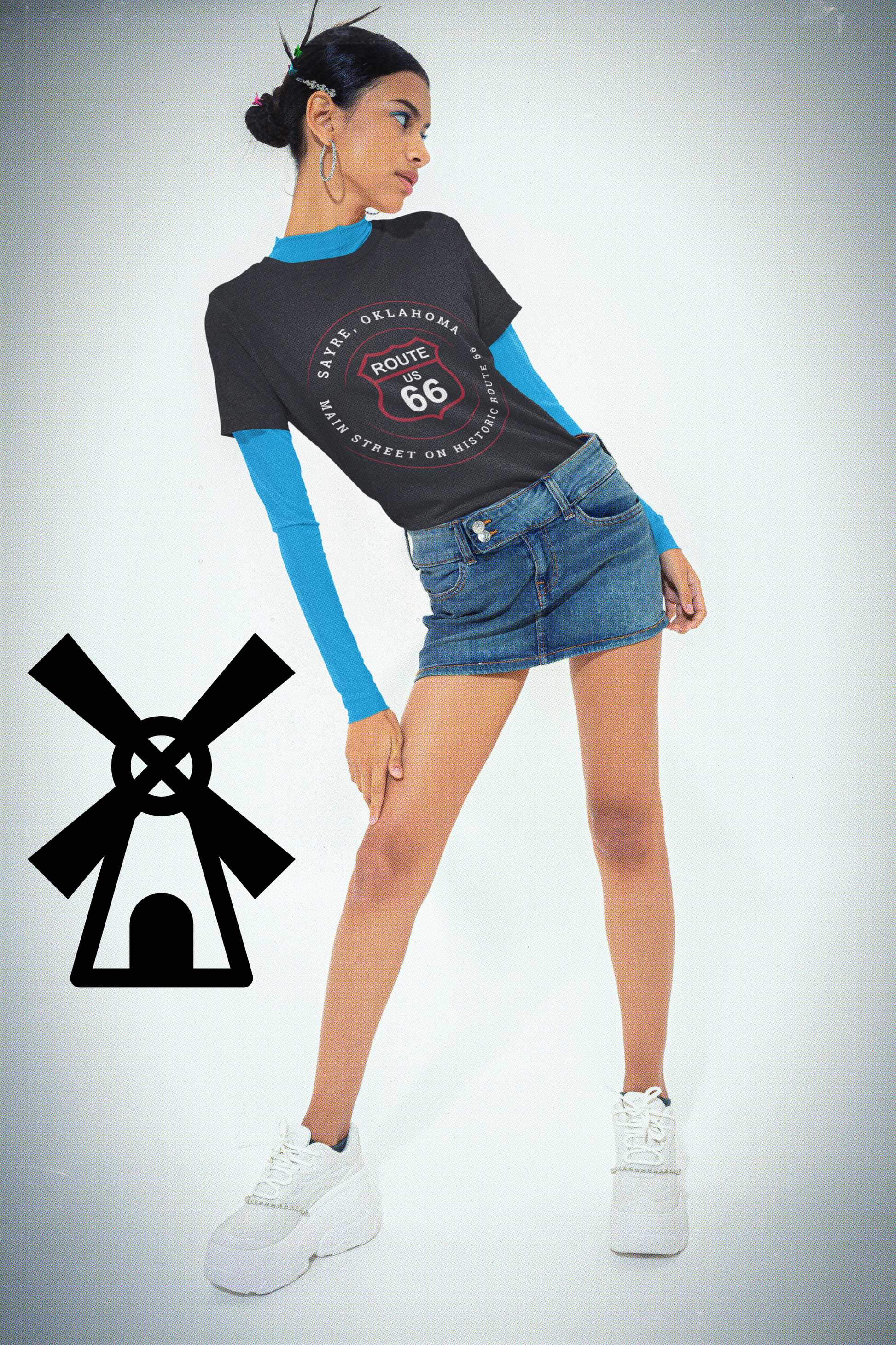 Female model wearing vintage black retro Route 66 unisex jersey tee with Sayre, OK "Main Street on Historic Route 66" design and an aqua colored long-sleeved shirt underneath