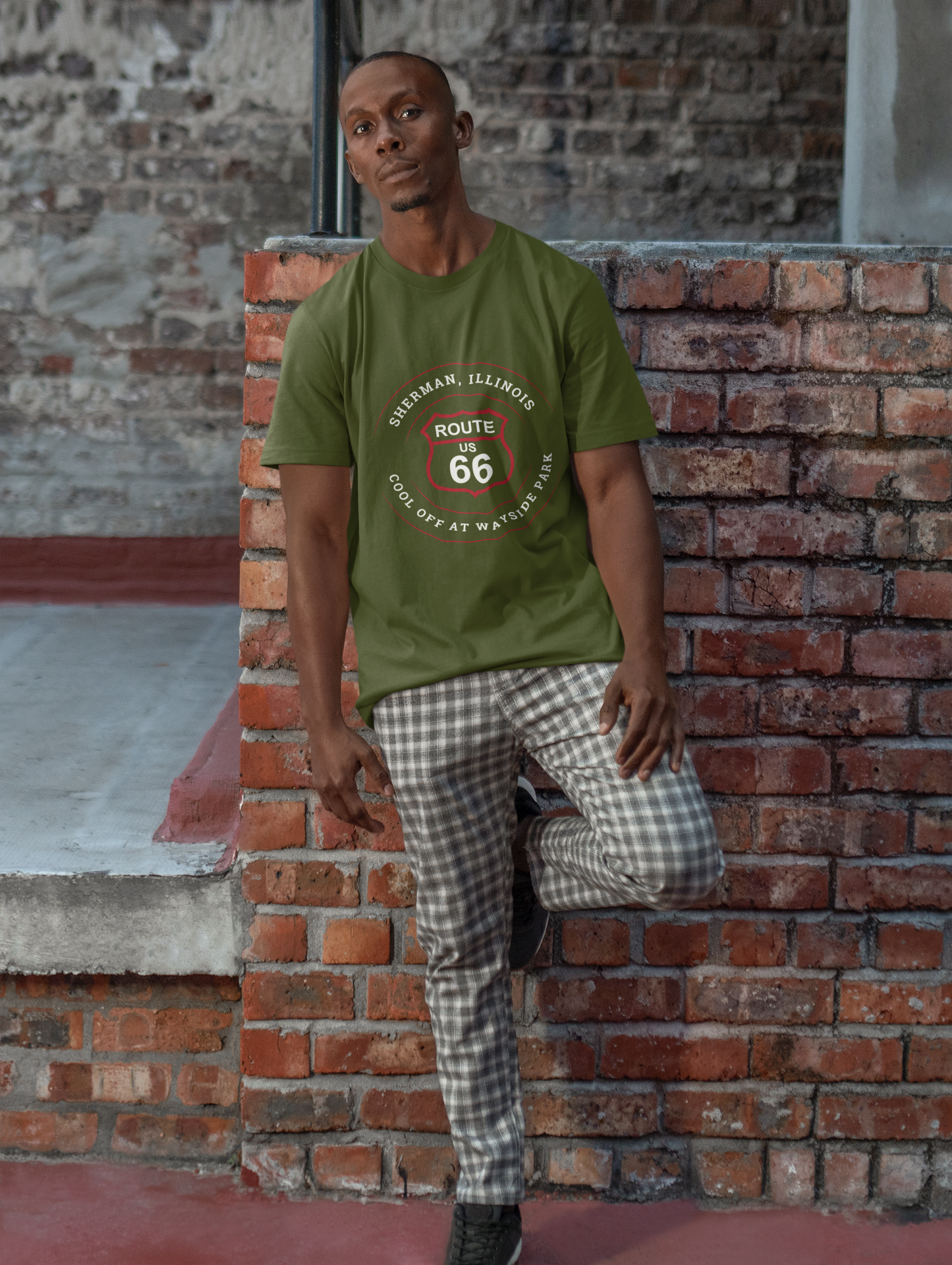 Male model wearing a black retro Route 66 unisex jersey tee with a Sherman, IL:: "Cool Off at Wayside Park" design