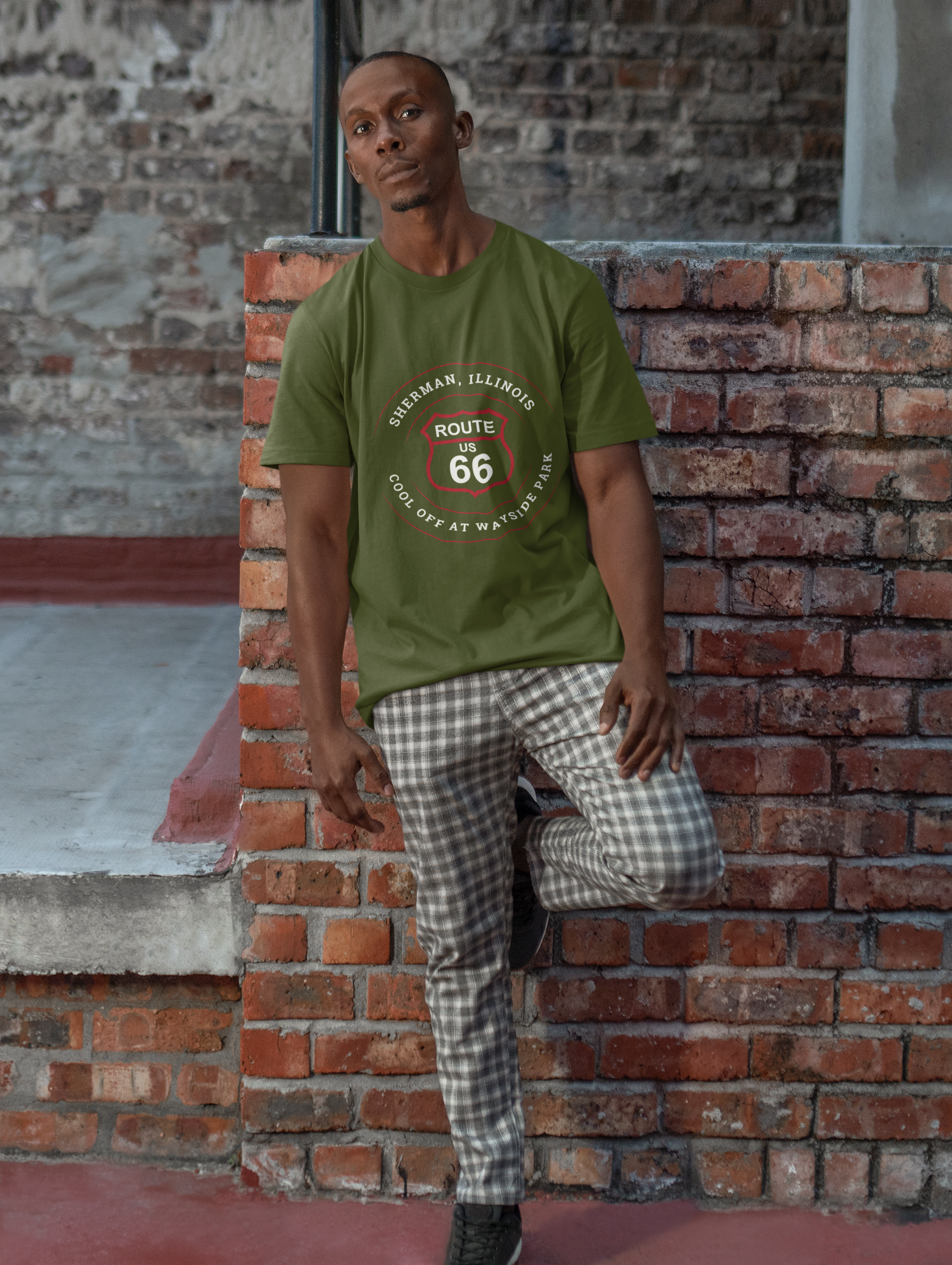 Male model wearing a black retro Route 66 unisex jersey tee with a Sherman, IL:: "Cool Off at Wayside Park" design