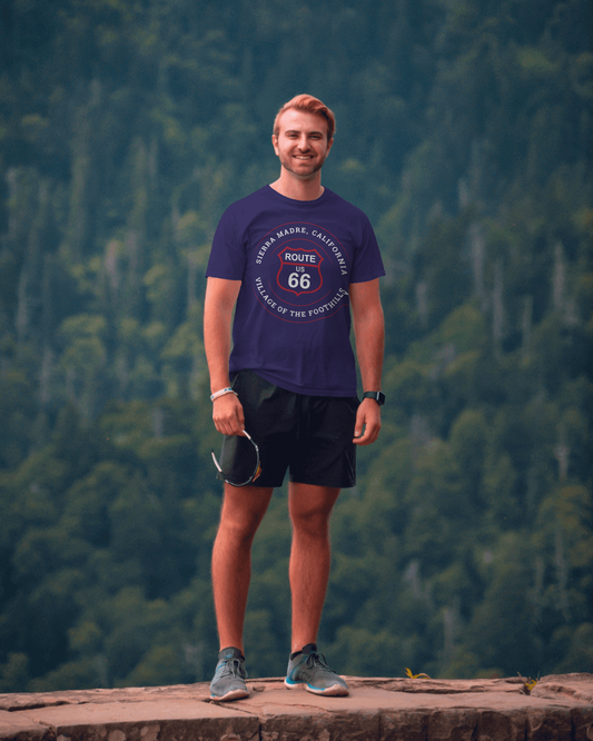 Male model in the San Gabriel Mountains wearing team navy retro Route 66 unisex jersey tee with Sierra Madre, CA: "Village of the Foothills" design