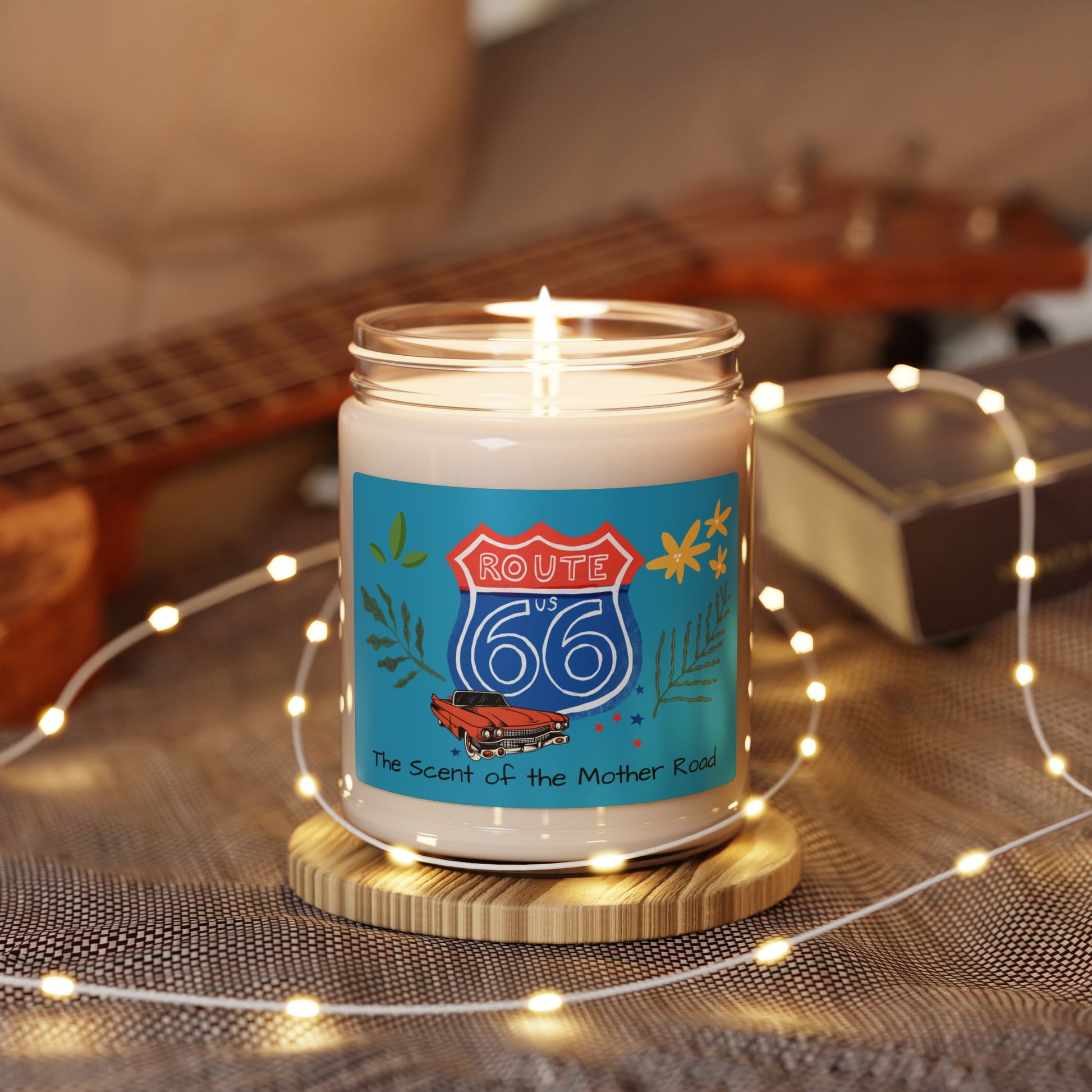 Route 66 Soy Candle glowing with string lights in a warm, cozy setting, evoking nostalgic road trip vibes.