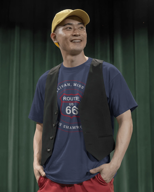 Male model wearing a black retro Route 66 unisex jersey tee with a Sullivan, MO: "Visit the Shamrock Motel" design