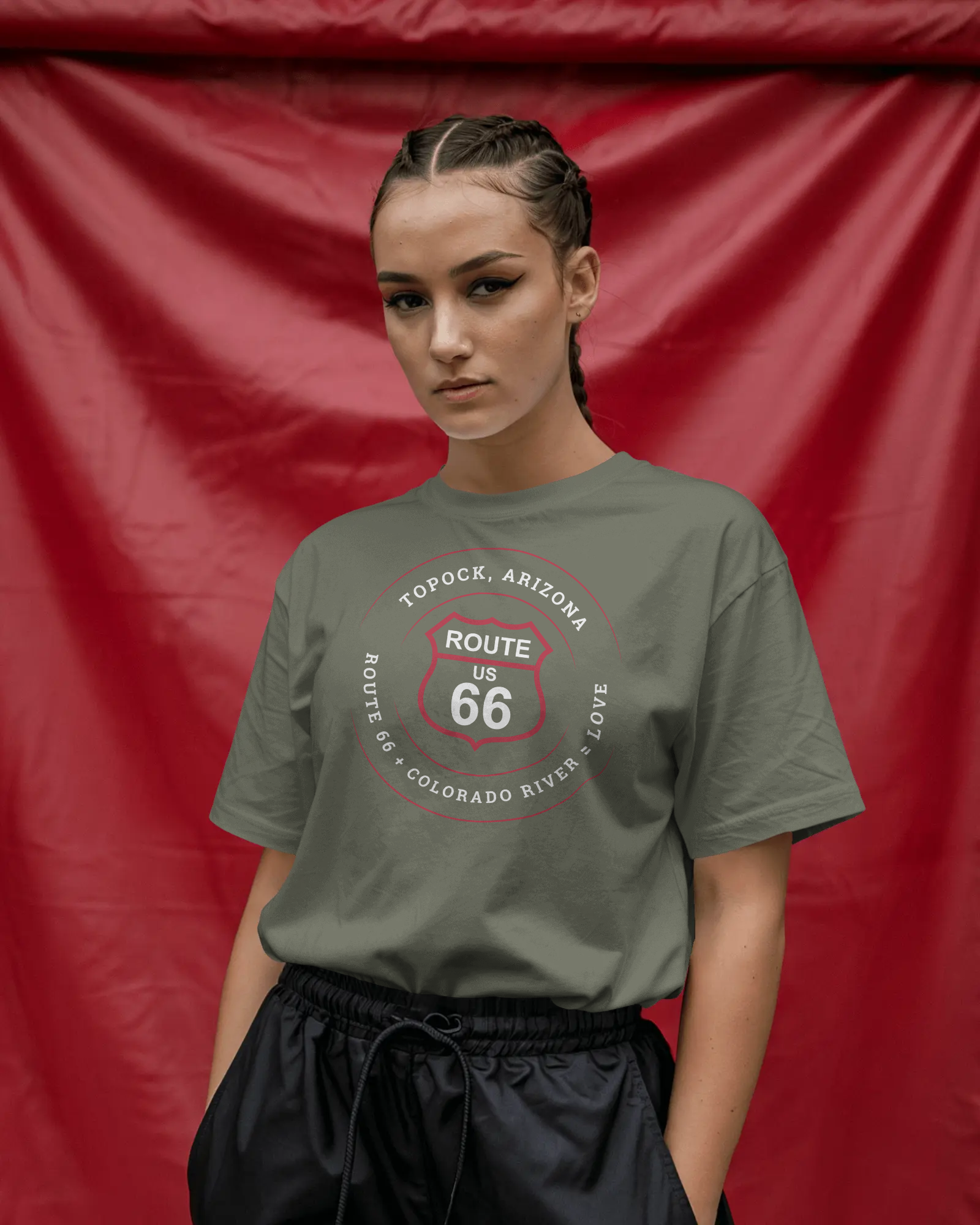 Female model wearing heather military green retro Route 66 unisex jersey tee with Topock, AZ: "Route 66 + Colorado River = Love" design