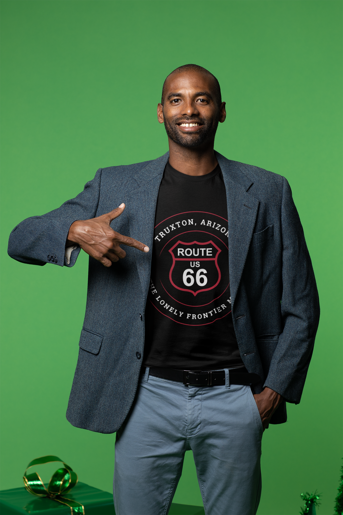 Male model wearing a black retro Route 66 unisex jersey tee with Truxton, AZ: "The Lonely Frontier Motel" design