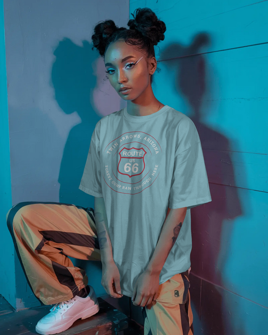 Female model wearing turquoise retro Route 66 unisex jersey tee with Twin Arrows, AZ: "Forrest Gump Ran Through Here" design