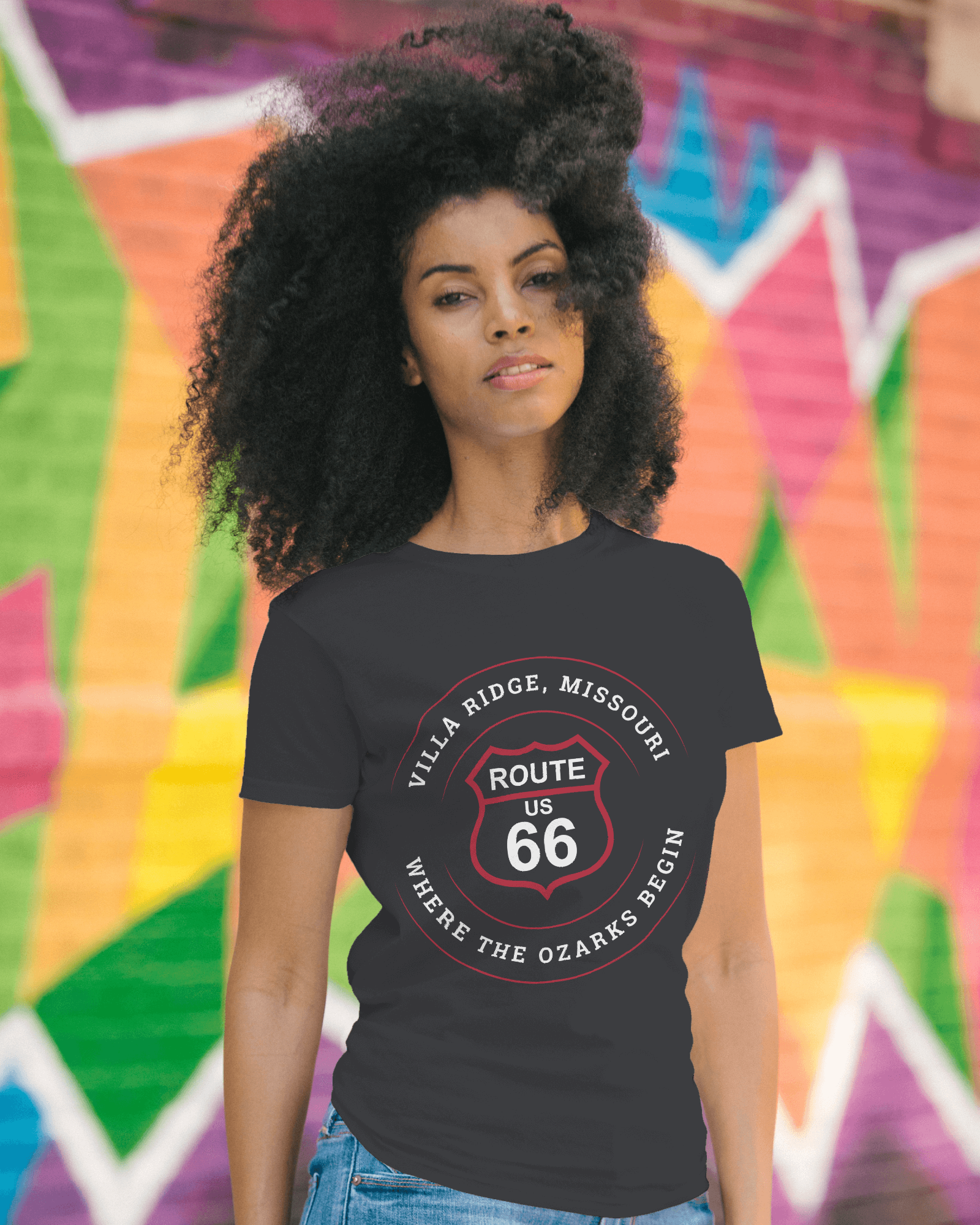 Female model wearing a vintage black retro Route 66 unisex jersey tee with a Villa Ridge, MO: "Where the Ozarks Begin" design