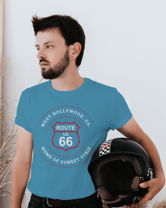 Male model holding a motorcycle helmet and wearing an aqua retro Route 66 unisex jersey tee with West Hollywood, CA: "Home of Sunset Strip" design
