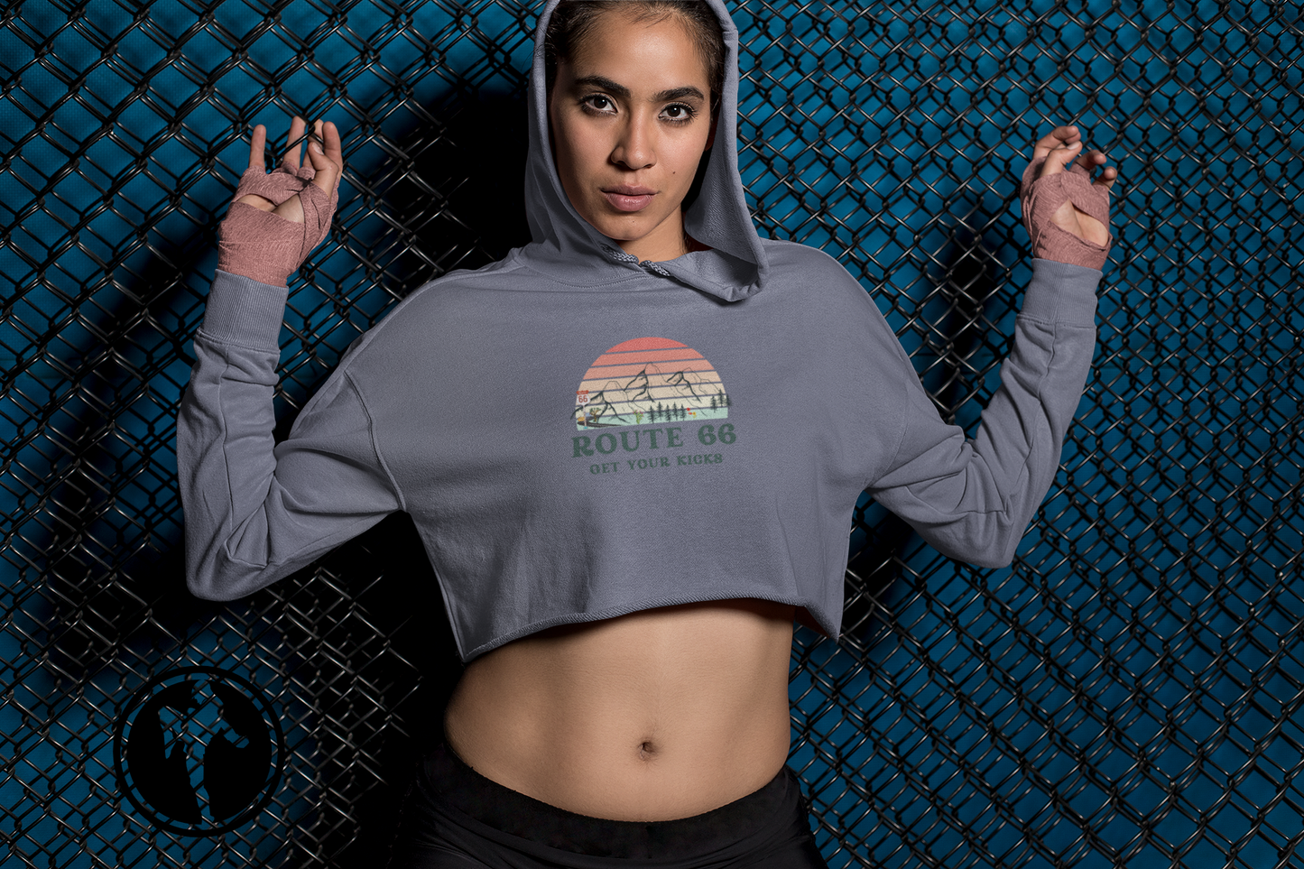 Female MMA fighter wearing Route 66 cropped hoodie with vintage sunset graphic - trendy casual outfit inspiration.