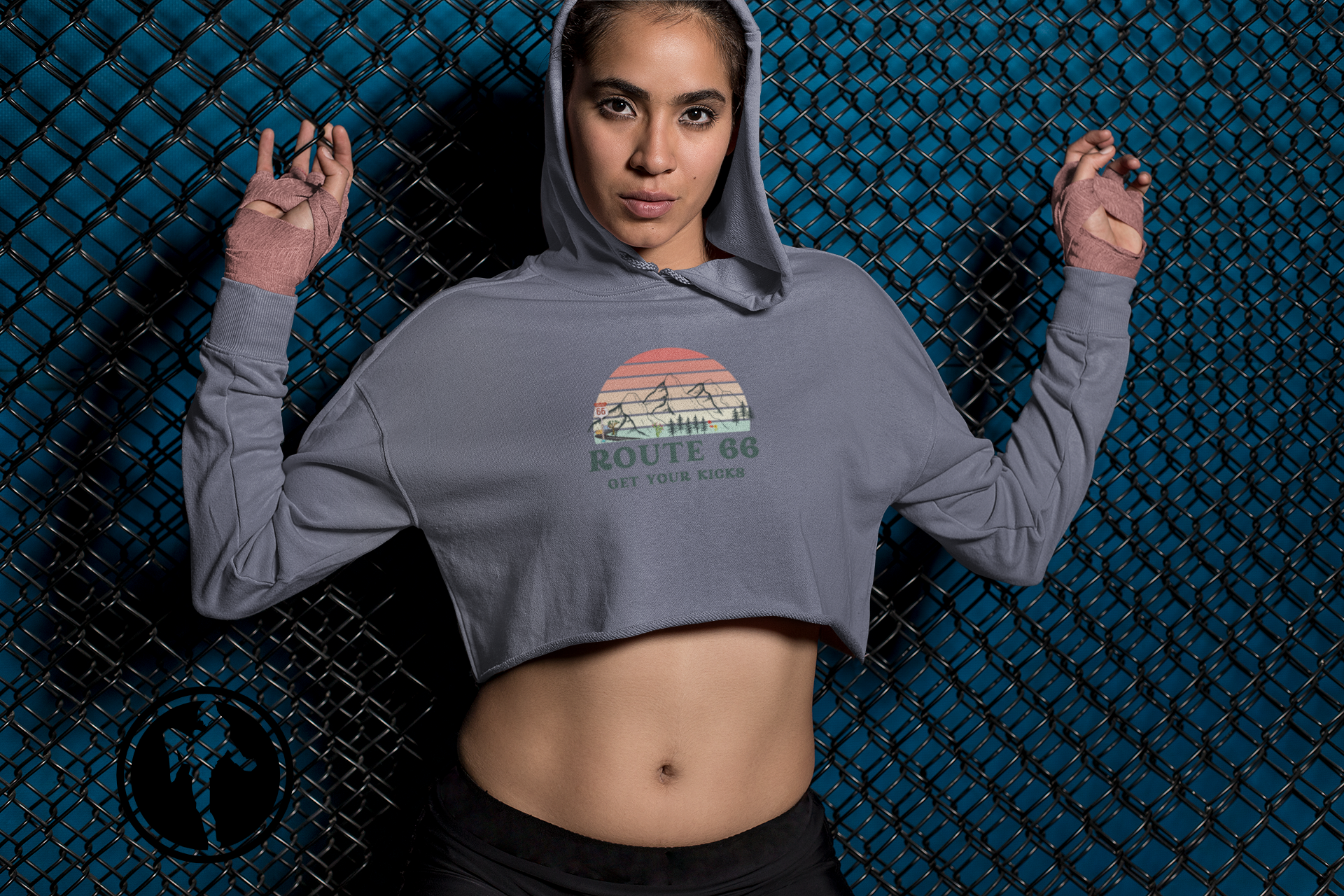 Female MMA fighter wearing Route 66 cropped hoodie with vintage sunset graphic - trendy casual outfit inspiration.