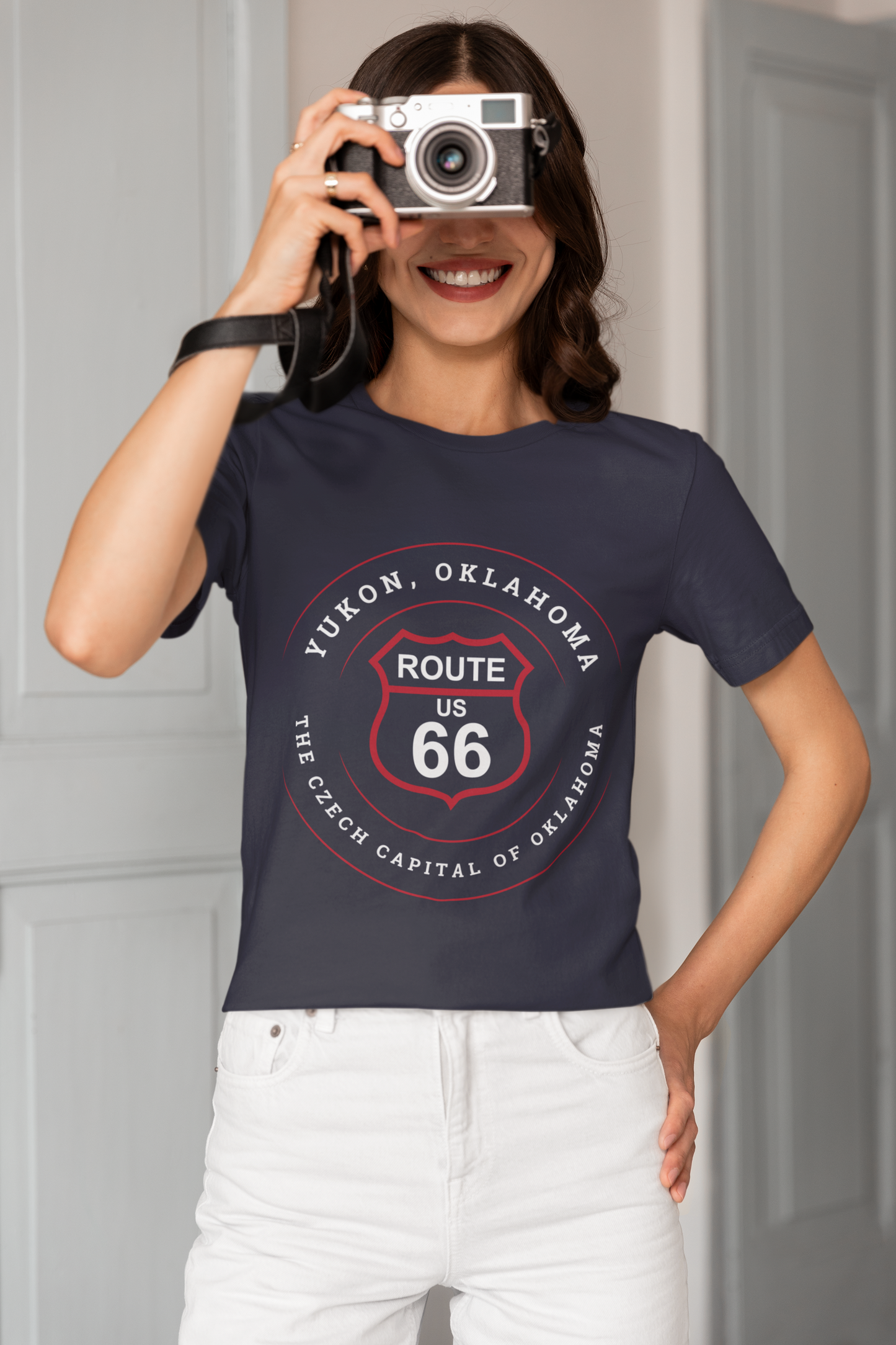 Female model wearing heather true royal retro Route 66 unisex jersey tee with Yukon, OK "Czech Capital of OK" design