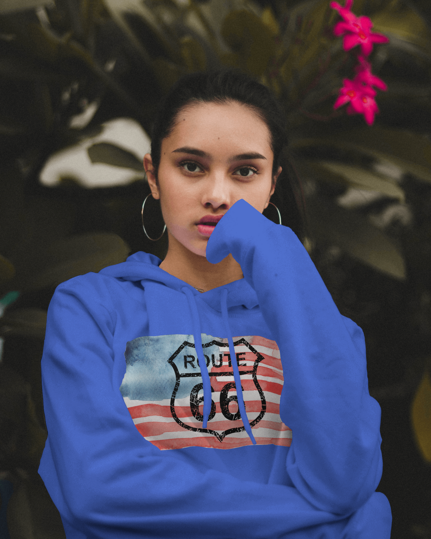 Woman wearing a true royal Route 66 hoodie with a watercolor-styled, distressed American flag design on the front
