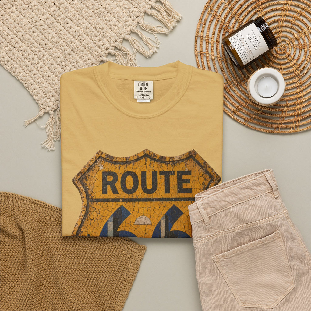 Vintage Shield Route 66 t-shirt in mustard, folded flat lay with jeans