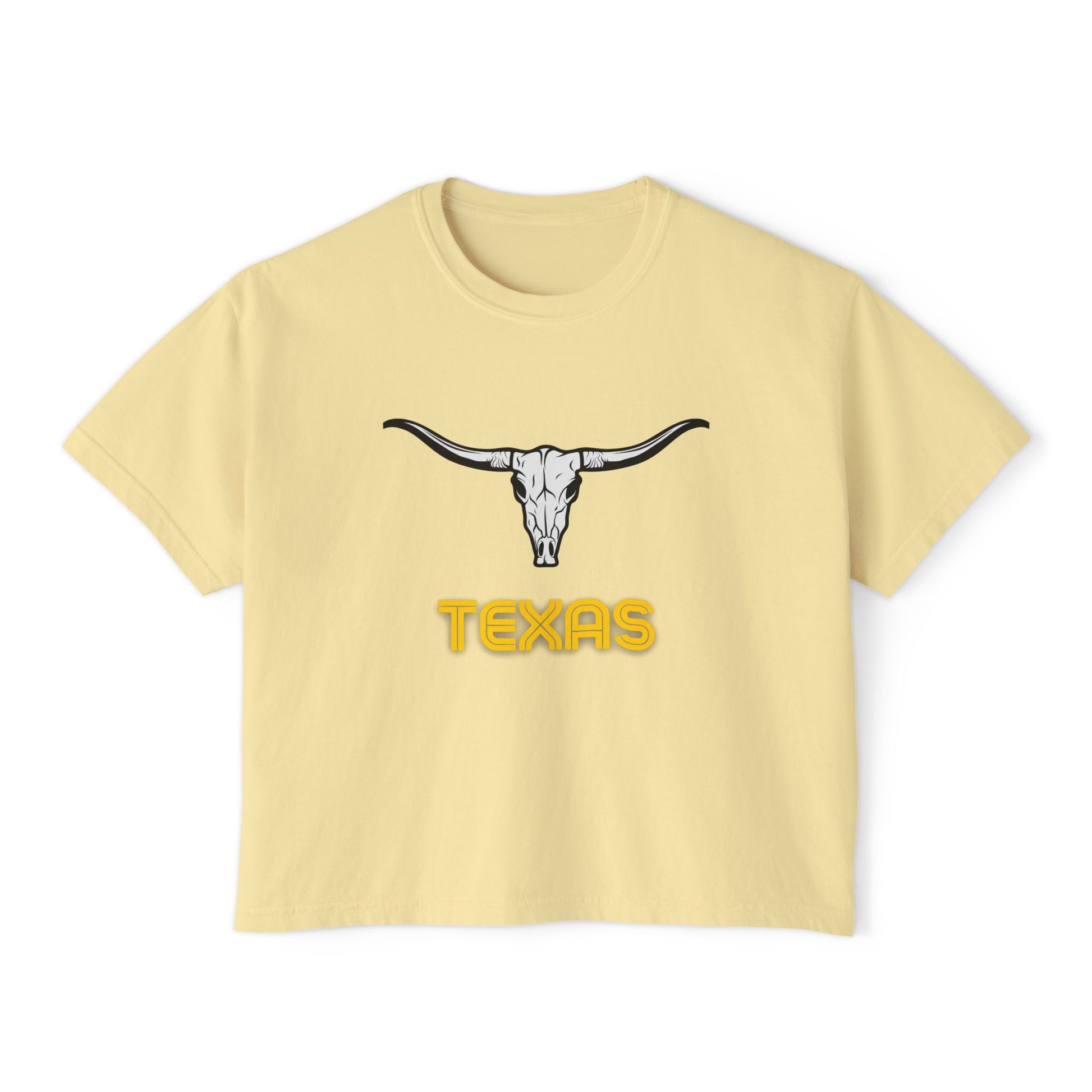 Flat lay of butter-yellow Texas Longhorn boxy tee featuring a black longhorn skull graphic and bold yellow "Texas" text